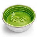 The Poppy Collection green ceramic dog bowl with paw print texture and white outer ridged design