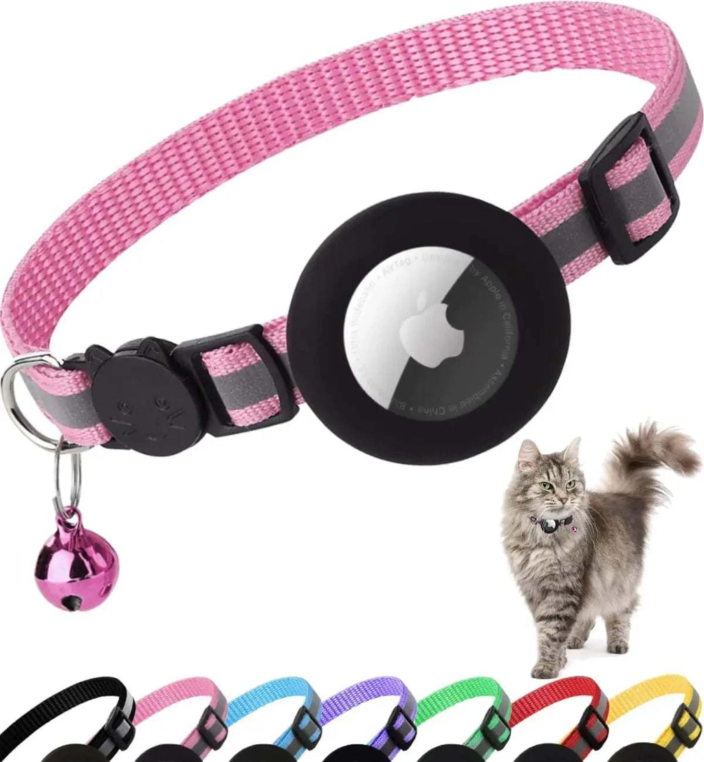 Pink nylon Breakaway Cat Collar with black elastic AirTag holder, reflective strip, black buckle, and a small pink bell charm.