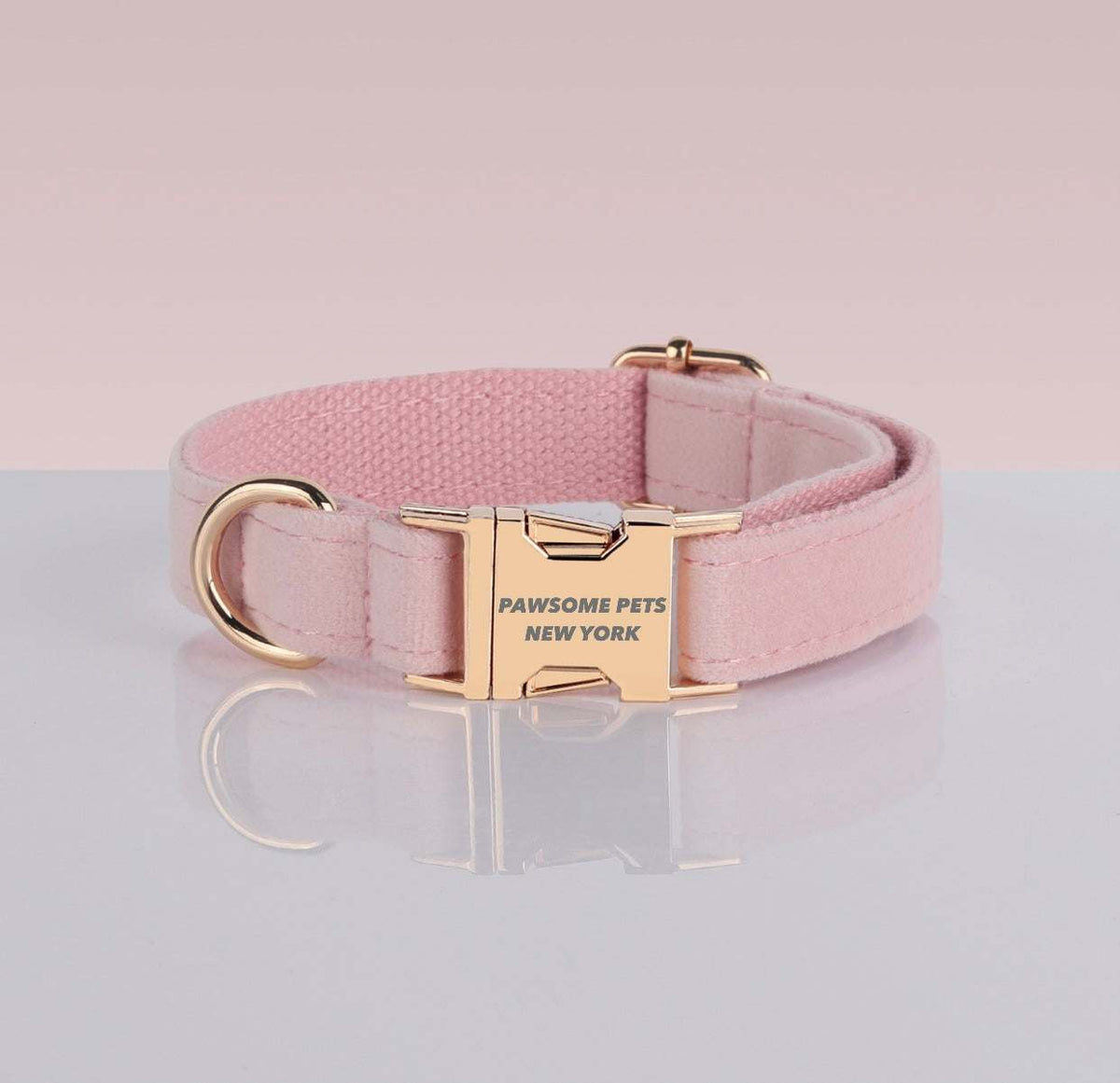 PAWSOME DOG COLLAR in light pink nylon webbing with gold-tone buckle and adjustable hardware, featuring "PAWSOME PETS NEW YORK" engraving.