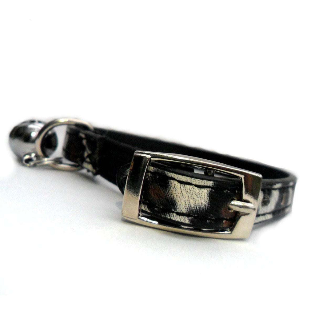 Leopard Print Cat Collar with black safety elastic, silver buckle, D-ring, and attached bell for added safety and style.