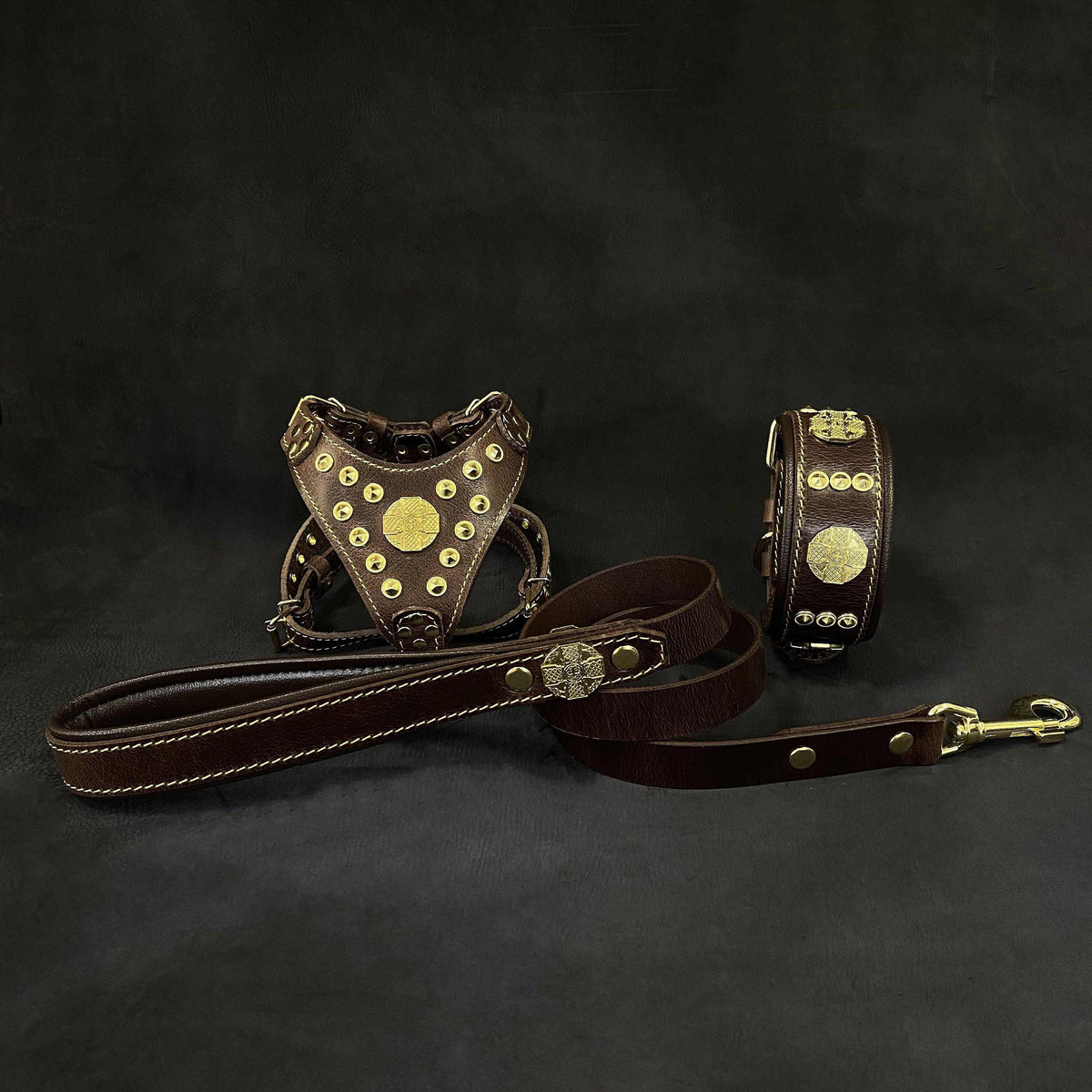 Maximus Brown Set featuring a small brown leather dog harness, collar, and leash with brass rivets and fittings.